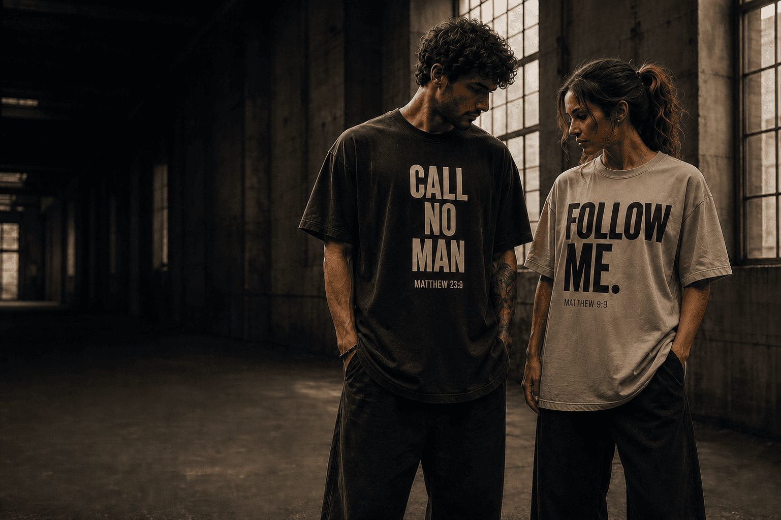 Man and woman wearing CALL NO MAN heavyweight streetwear in an industrial space